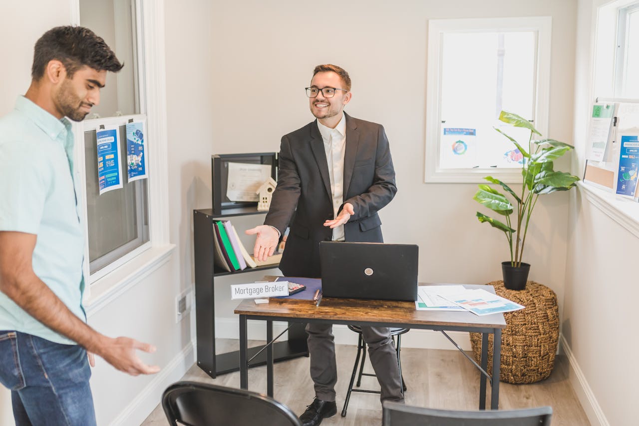 gallery-04 A professional business interaction in a modern office with a mortgage broker and client.